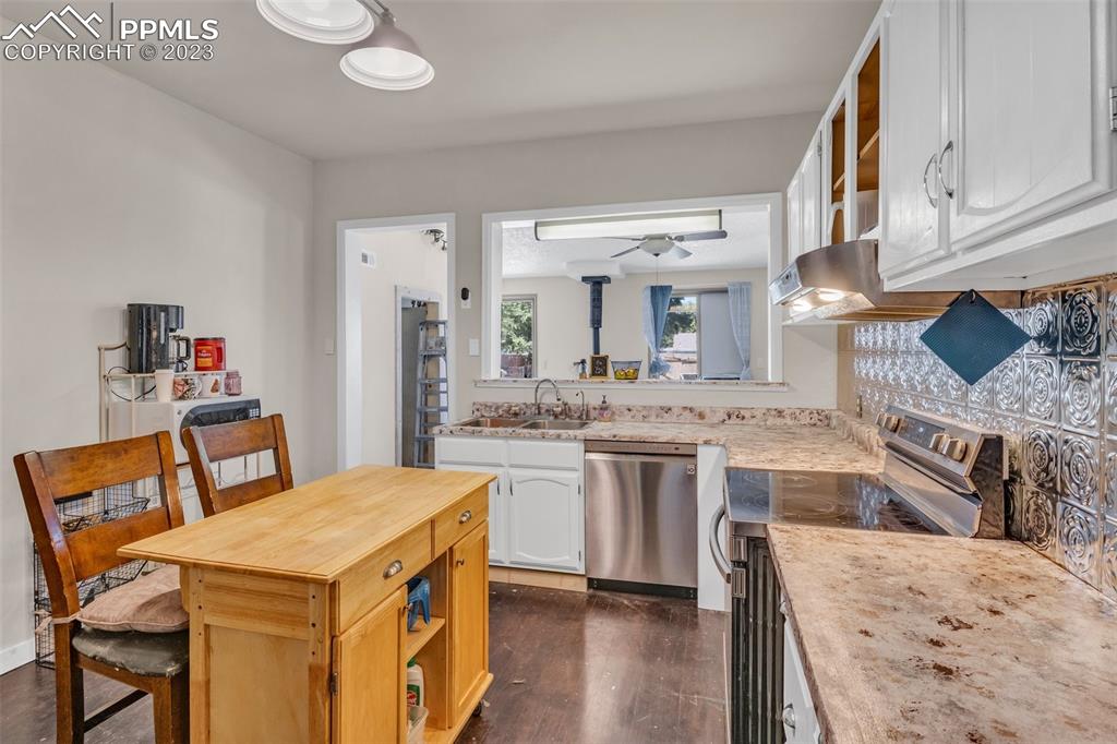 1330 West 3rd Street Florence, CO 81226 - Photo 9 of 34 a large kitchen with a table and chairs in it