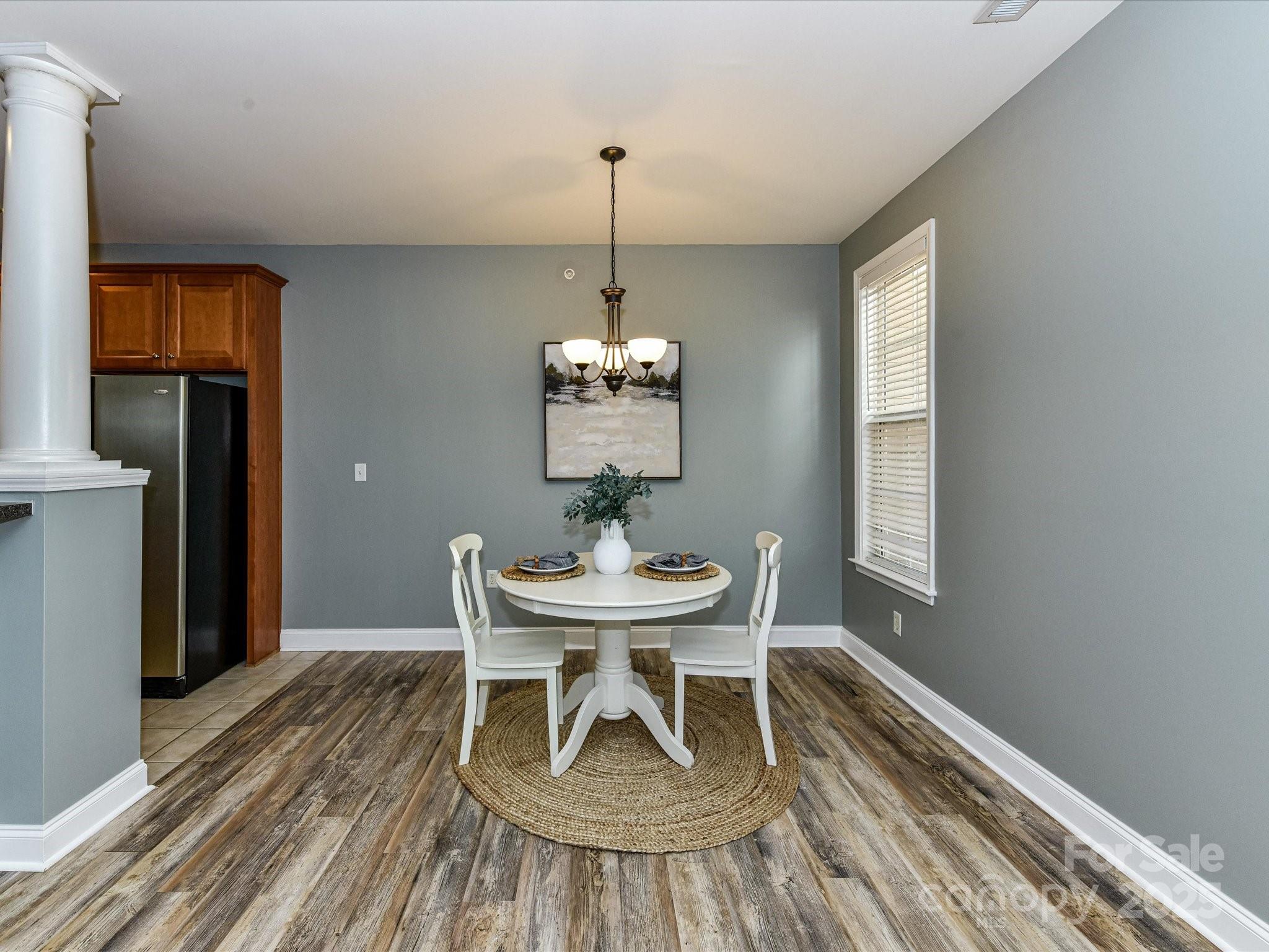 9065 Rosalyn Glen Road Cornelius, NC 28031 - Photo 11 of 35 a dining room with furniture and window