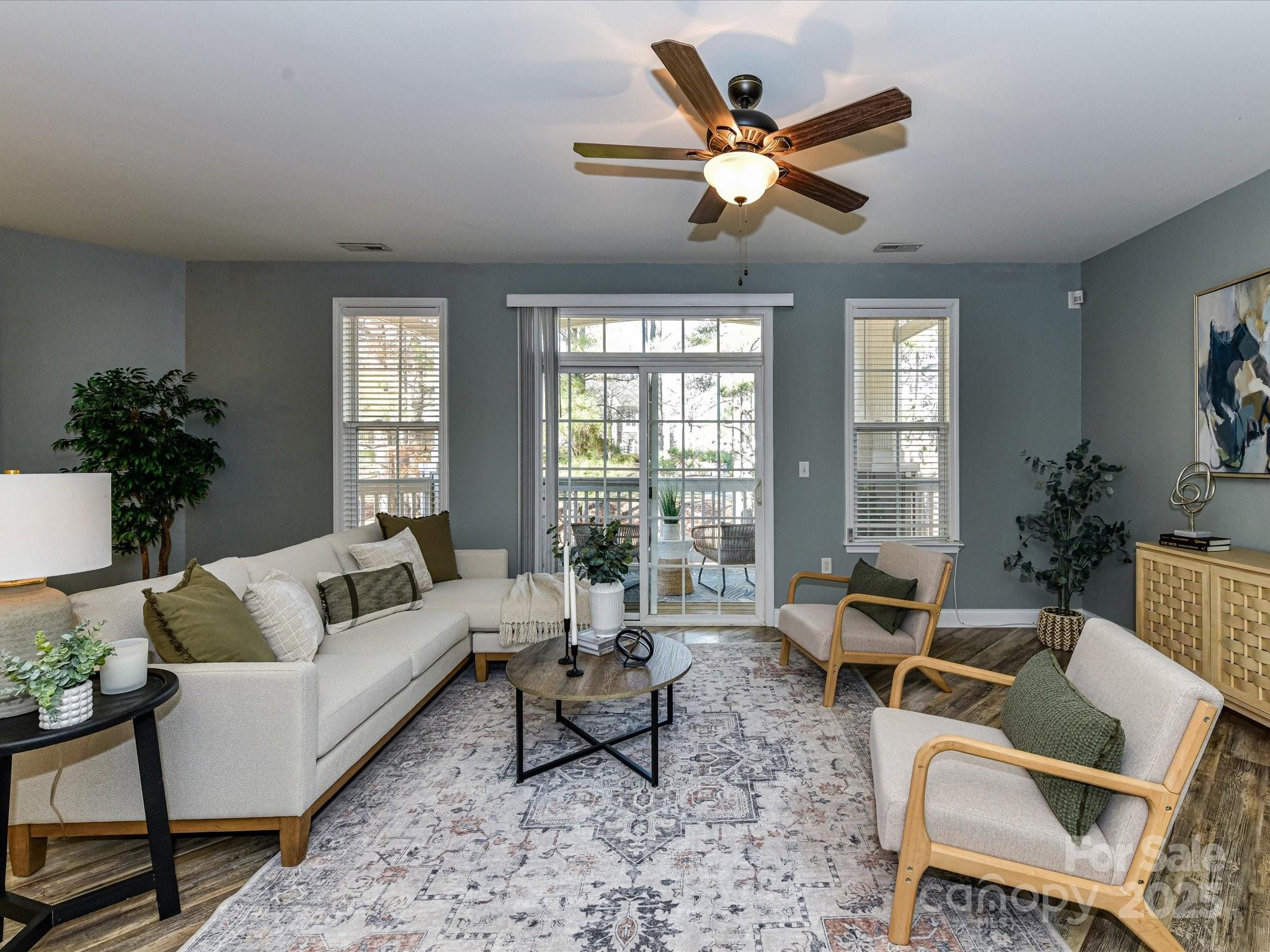 9065 Rosalyn Glen Road Cornelius, NC 28031 - Photo 12 of 35 a living room with furniture ceiling fan and a large window