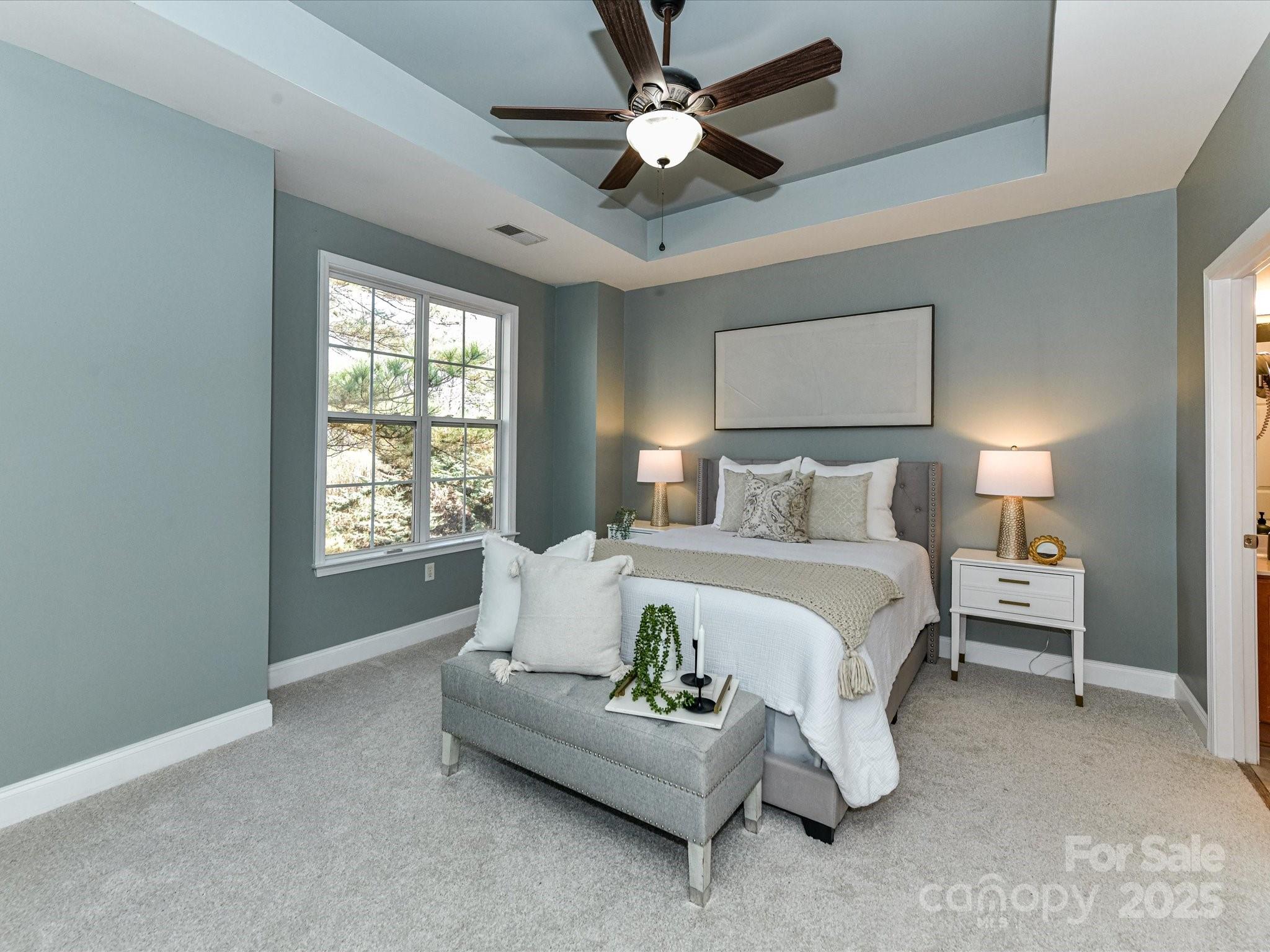 9065 Rosalyn Glen Road Cornelius, NC 28031 - Photo 15 of 35 a spacious bedroom with a bed couch and window