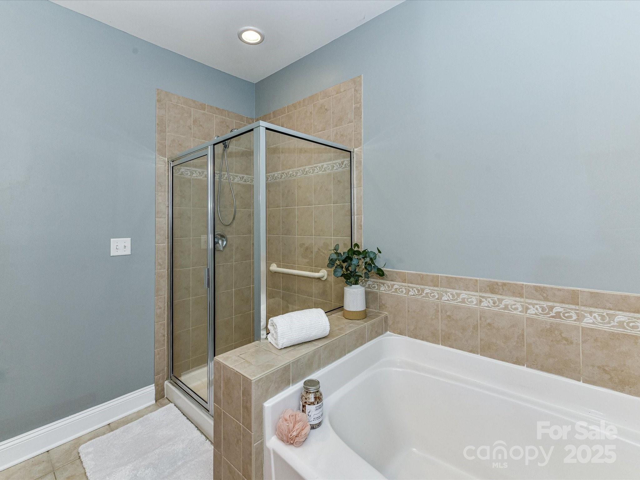 9065 Rosalyn Glen Road Cornelius, NC 28031 - Photo 18 of 35 a bathroom with a tub and shower