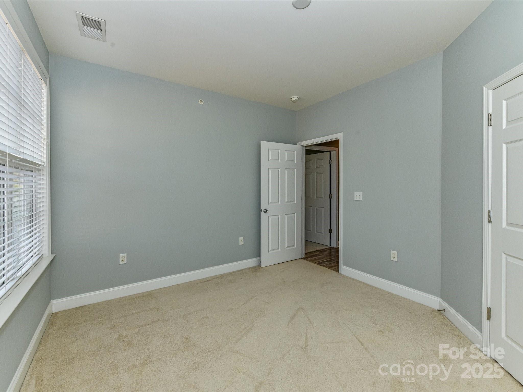 9065 Rosalyn Glen Road Cornelius, NC 28031 - Photo 21 of 35 an empty room with windows and closet