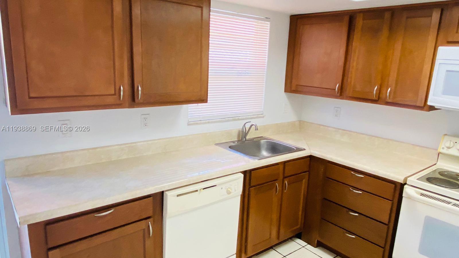 5407 Northwest 27th Street, Unit D2 Lauderhill, FL 33313 - Photo 11 of 21 a kitchen with a sink and cabinets