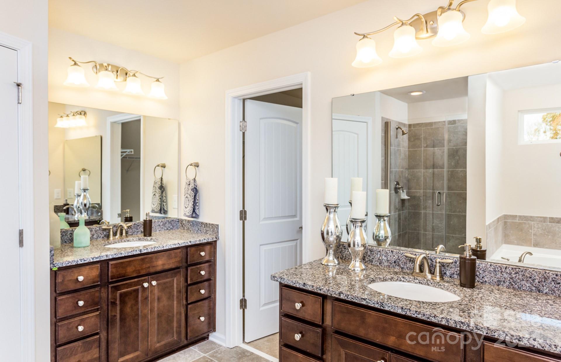 2233 Millenium Drive, Unit 13 Lancaster, SC 29720 - Photo 15 of 15 a bathroom with a granite countertop double vanity sink and a mirror