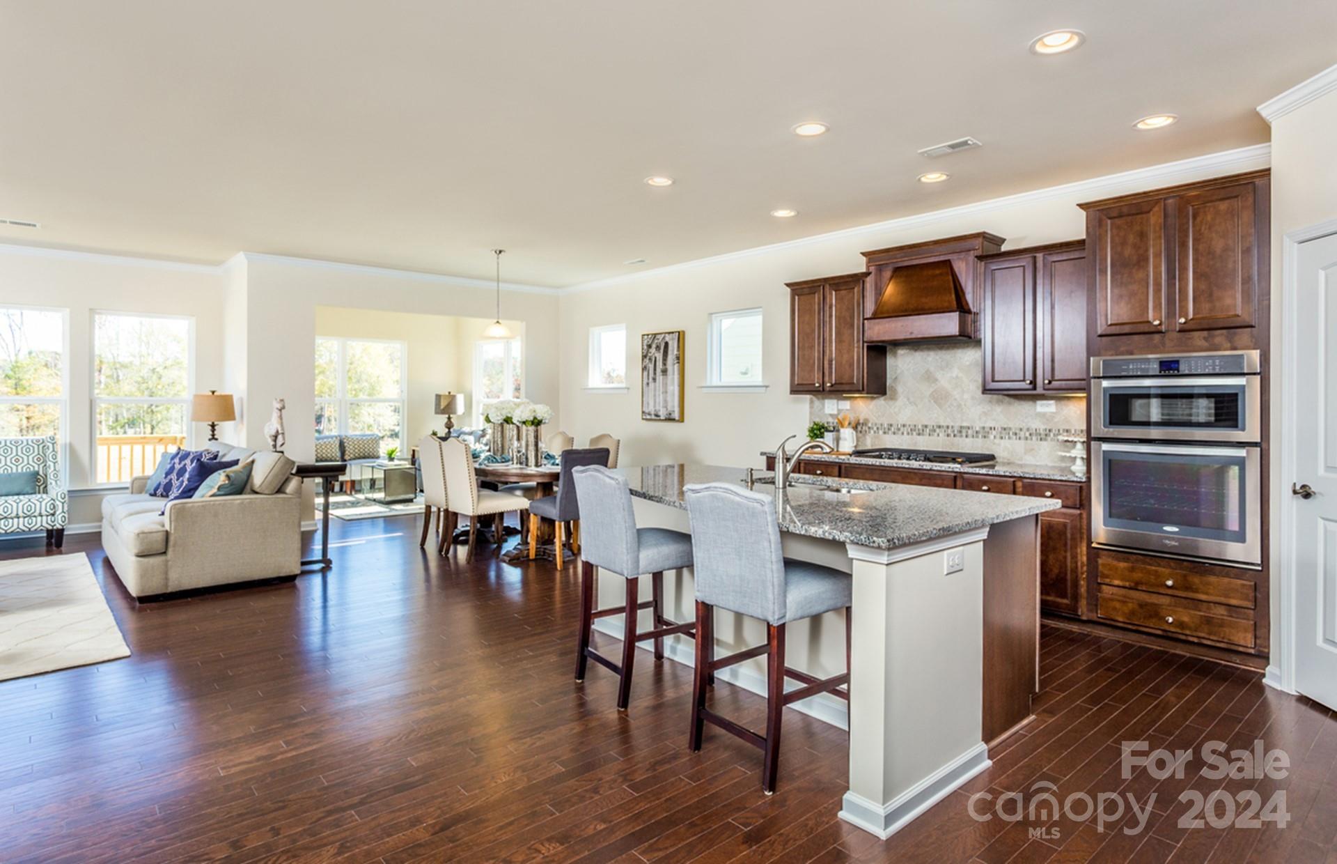 2233 Millenium Drive, Unit 13 Lancaster, SC 29720 - Photo 5 of 15 a kitchen with stainless steel appliances granite countertop a stove top oven a sink a counter top space and cabinets