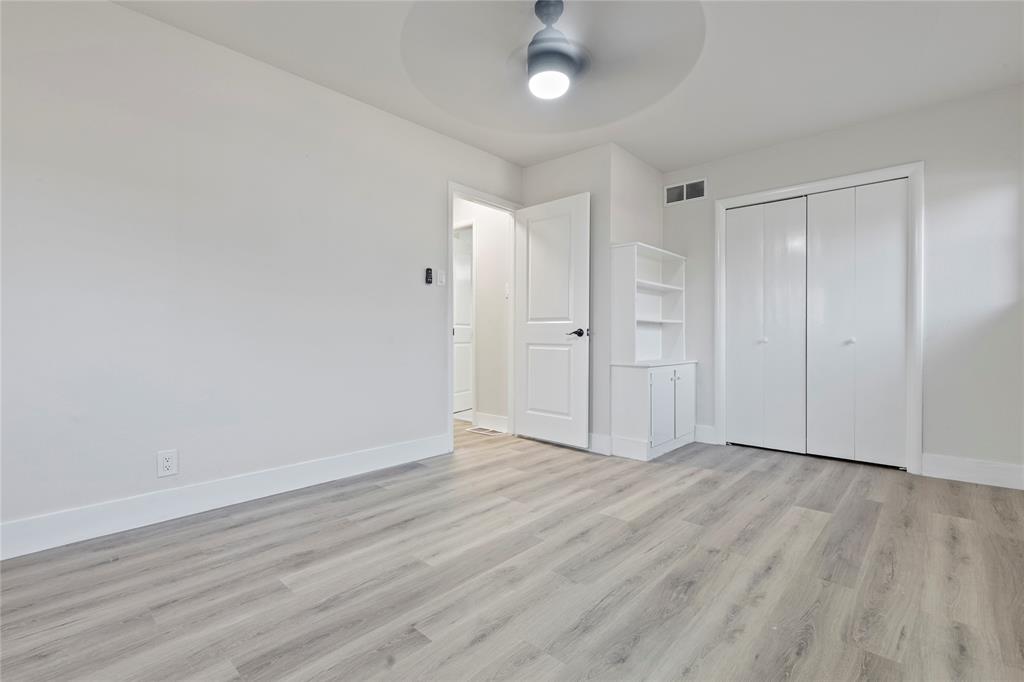 706 Commerce Street Euless, TX 76040 - Photo 12 of 28 a view of an empty room with wooden floor