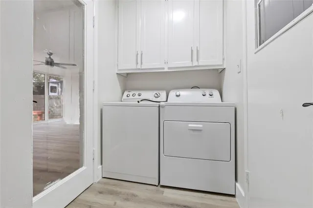 a view of washer and dryer with kitchen in the background