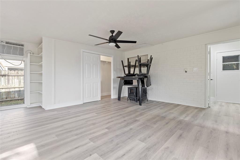 706 Commerce Street Euless, TX 76040 - Photo 17 of 28 wooden floor in an empty room with a window