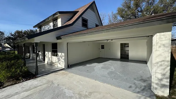 a view of a house with a garage and balcony