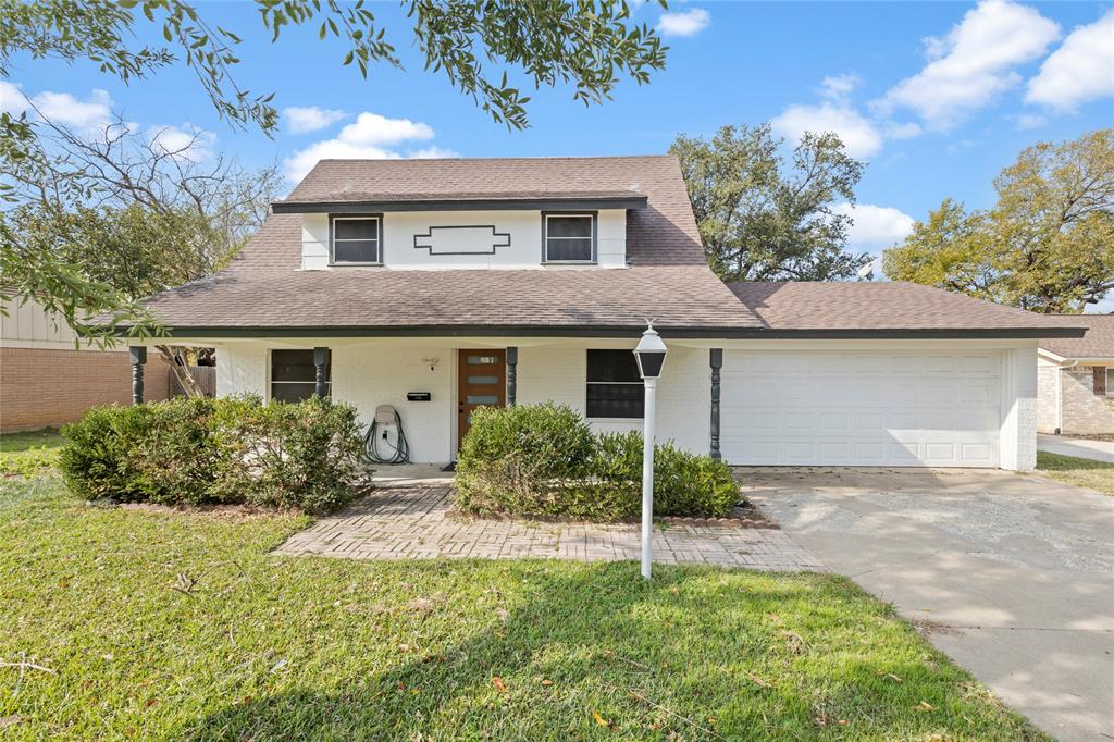 706 Commerce Street Euless, TX 76040 - Photo 25 of 28 a front view of house with yard and trees in the background