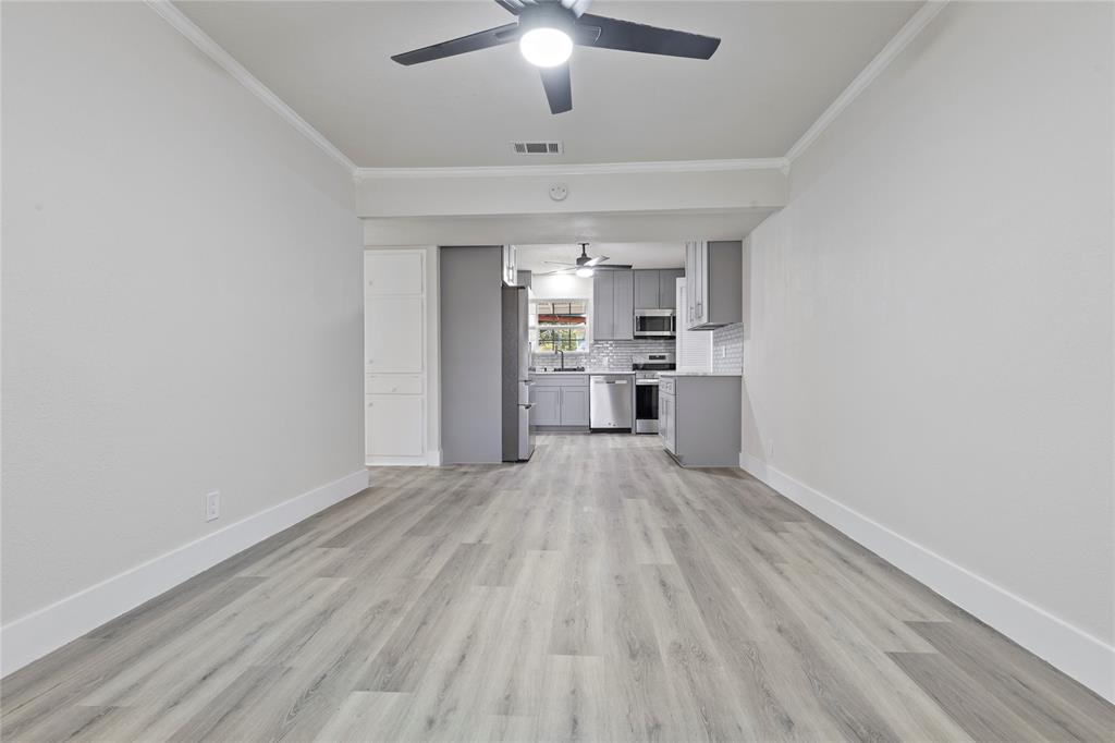 706 Commerce Street Euless, TX 76040 - Photo 3 of 28 wooden floor in an empty room with a window