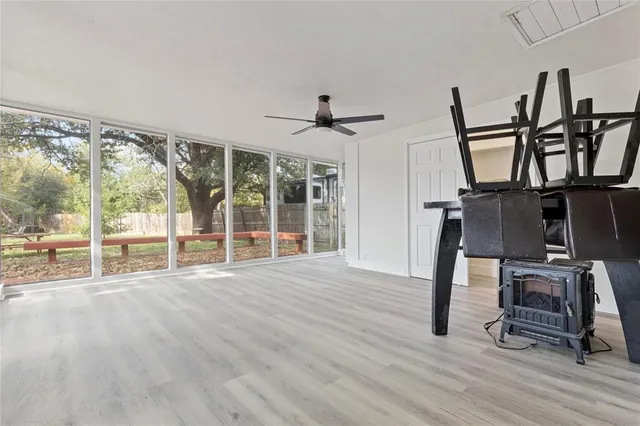 a view of an empty room with wooden floor windows and a wooden floor