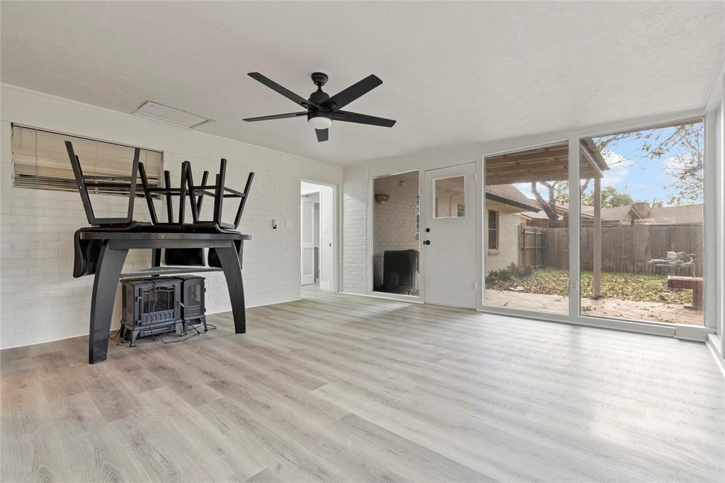 706 Commerce Street Euless, TX 76040 - Photo 6 of 28 a view of a livingroom with a hardwood floor and a ceiling fan