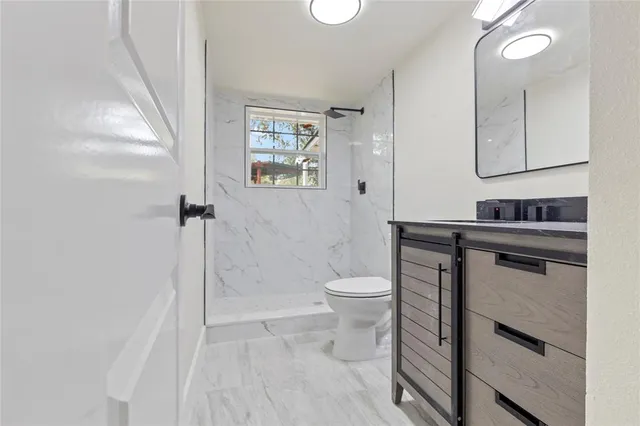 a bathroom with a toilet sink and a mirror