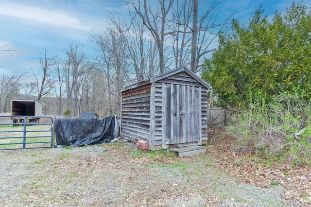 a view of a house with a yard and wooden fence
