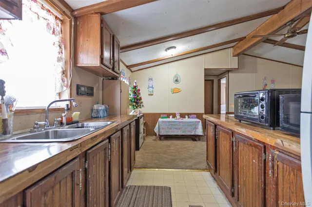 a kitchen with granite countertop a sink stove and cabinets