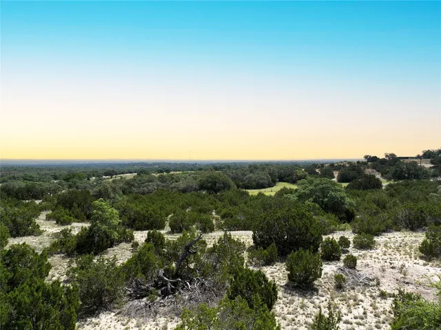 an aerial view of residential houses with city view