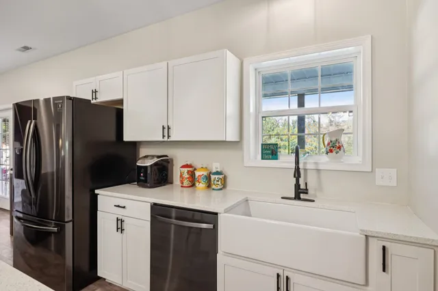 a kitchen with stainless steel appliances a stove a sink and a refrigerator