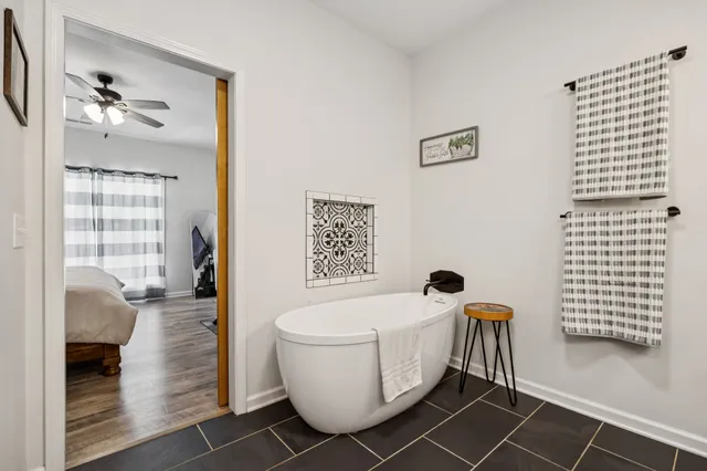 a bedroom with a bed and a tv on the dresser