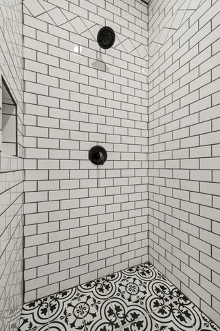 a bathroom with a granite countertop sink a mirror and cabinets