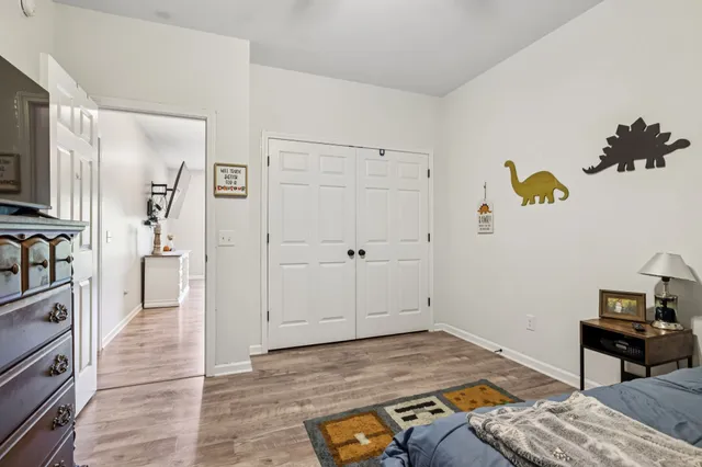 a bedroom with a bed and a dresser