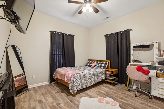 a view of a big yard with large trees