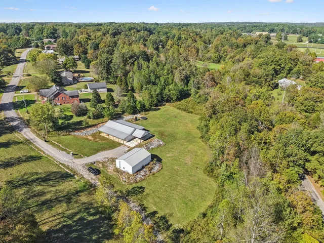 a front view of a house with a garden and yard