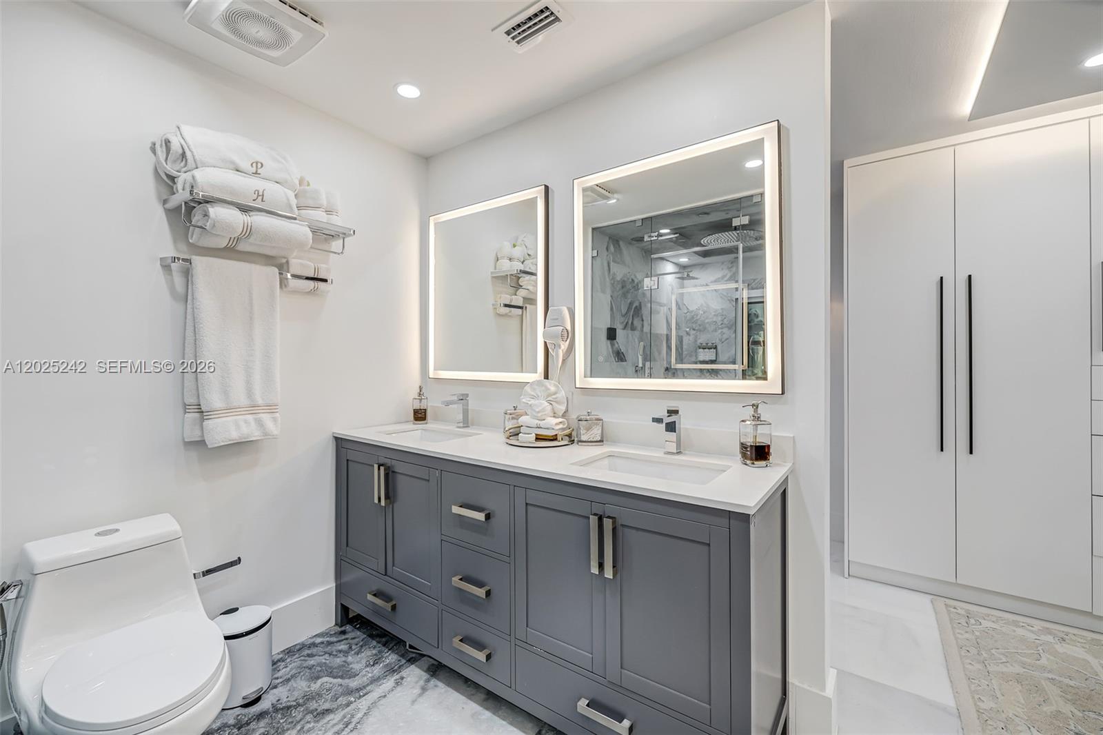 8761 Southwest 56th Street Miami, FL 33165 - Photo 51 of 90 a bathroom with a toilet a sink and mirror