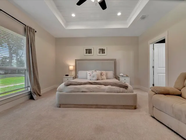 a spacious bedroom with a bed and a couch