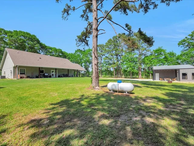 a view of an house with backyard space and garden