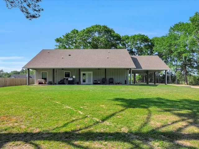 a aerial view of a house with swimming pool and big yard