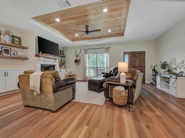 a living room with fireplace furniture and a flat screen tv