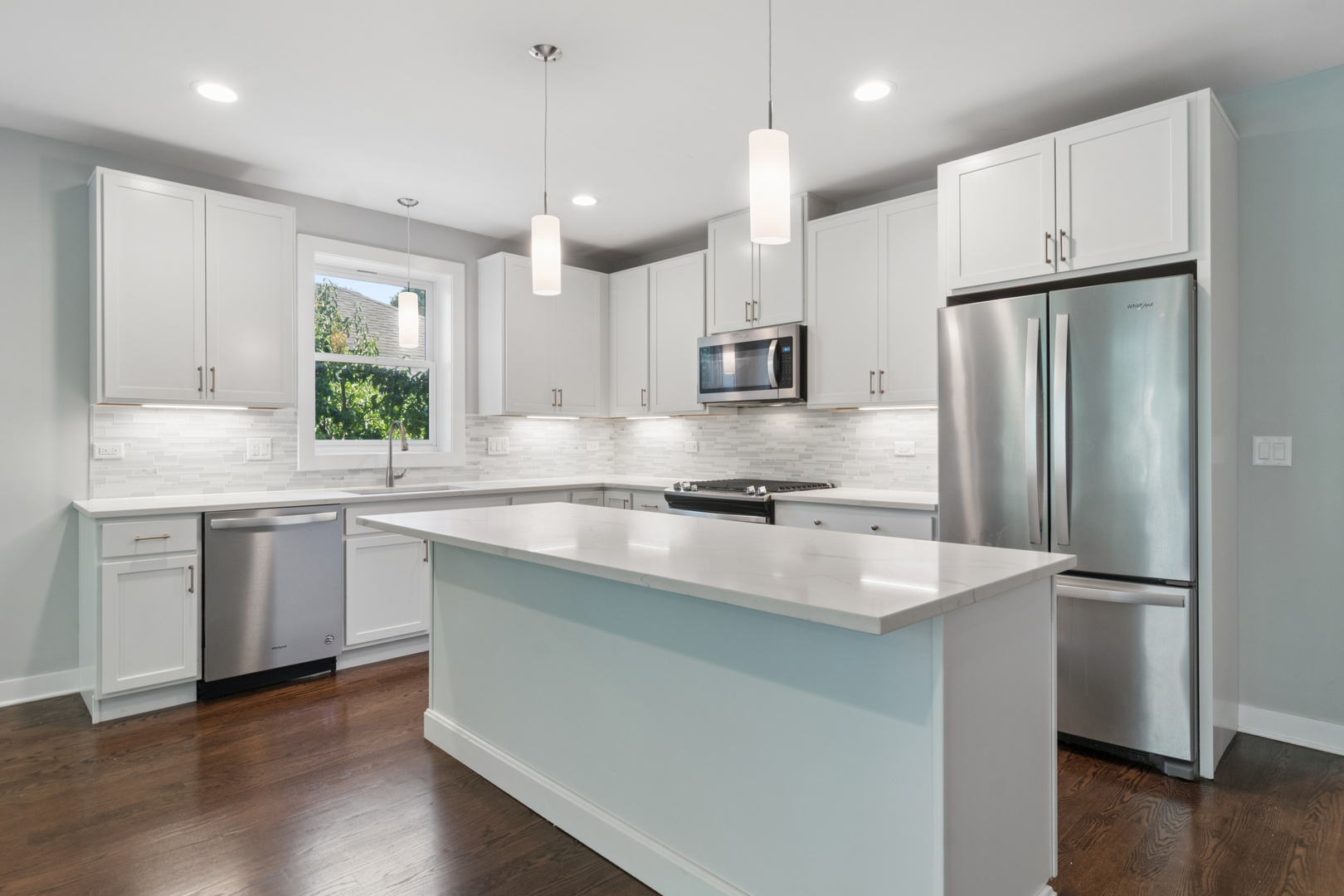 4845 North Keystone Avenue, Unit 2N Chicago, IL 60630 - Photo 5 of 21 a kitchen with kitchen island granite countertop a sink appliances a counter space and a window