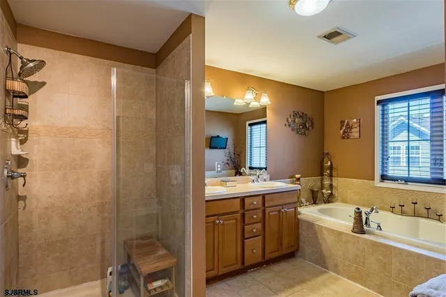 a bathroom with a tub sink and mirror