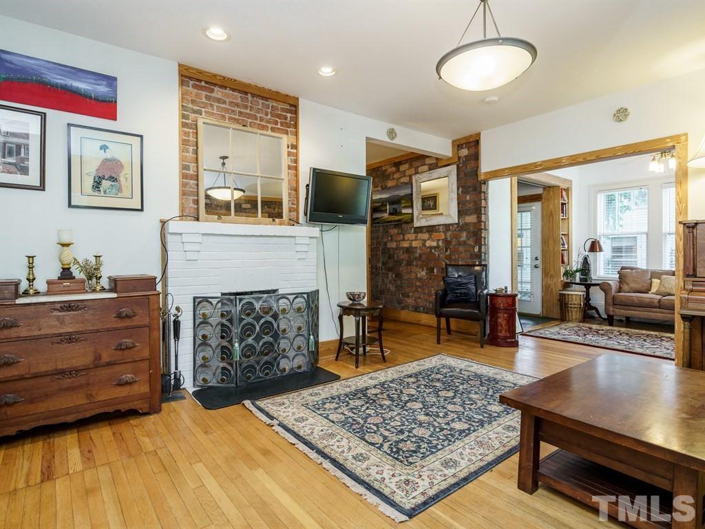 511 Florence Street Raleigh, NC 27603 - Photo 5 of 24 Natural wood trim was added throughout that blends nicely with the warmth of the exposed brick.