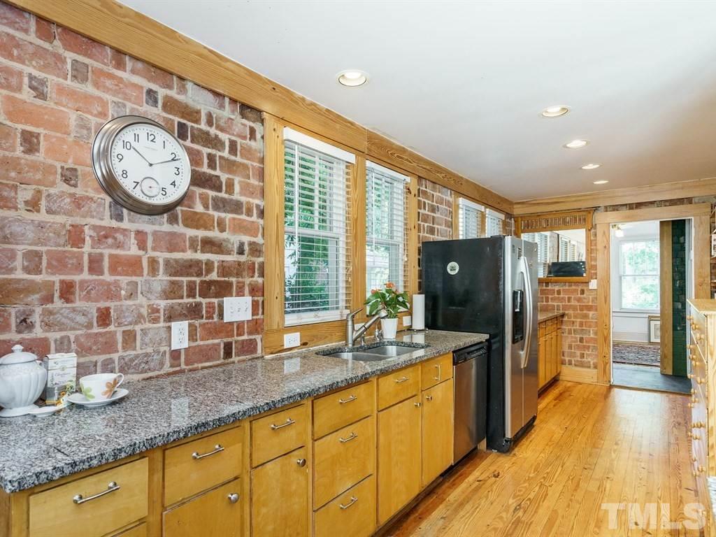511 Florence Street Raleigh, NC 27603 - Photo 8 of 24 Great circular flow for entertaining. The Kitchen leads forward to the Sun Room.