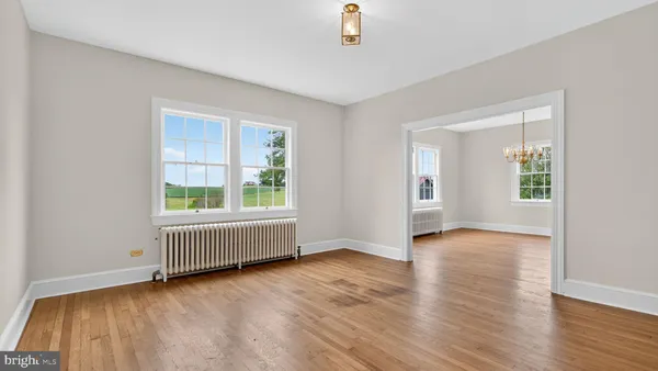 wooden floor in an empty room with a window and wooden floor