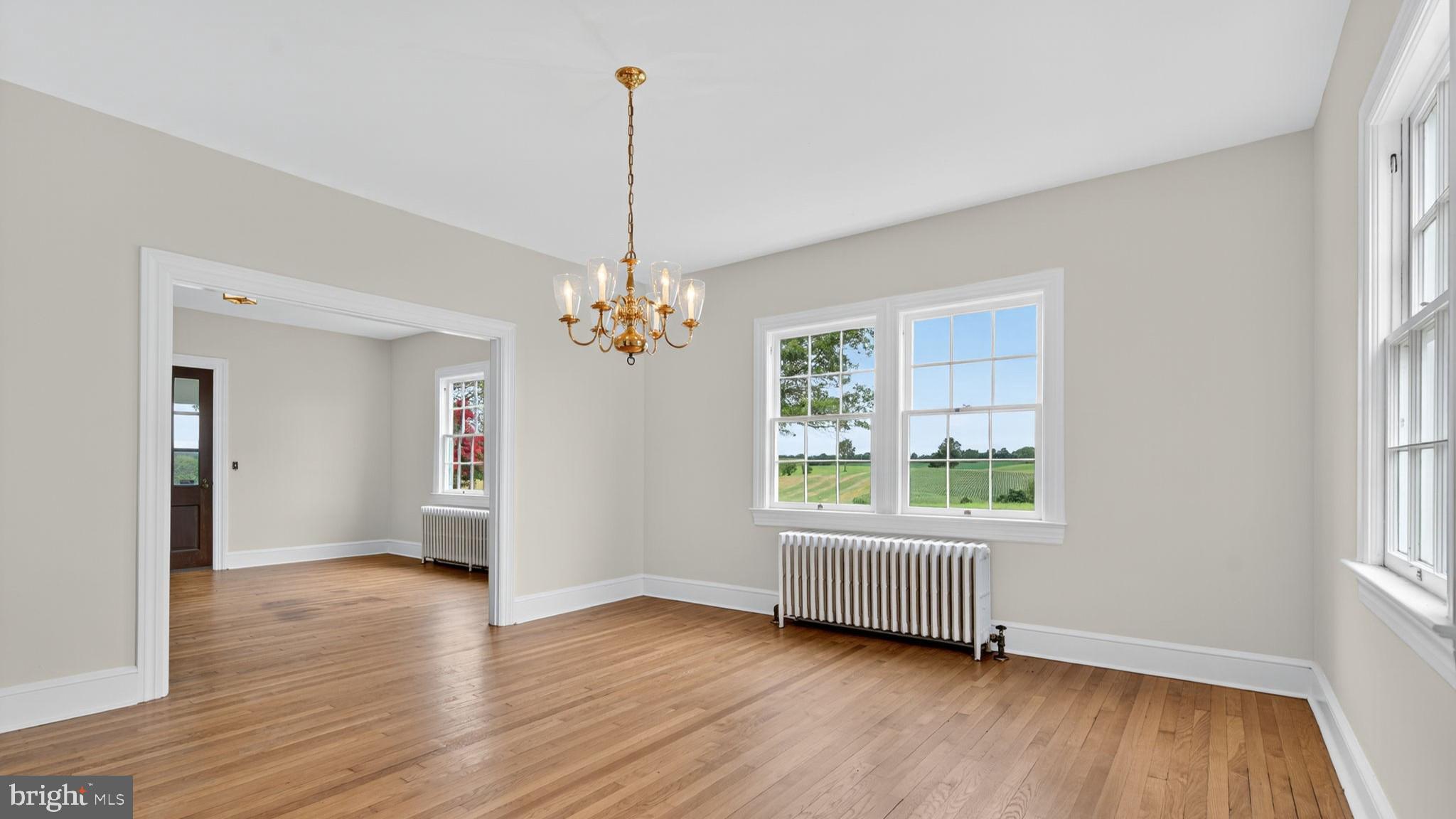 9534 Spring Hill Lane Rixeyville, VA 22737 - Photo 36 of 70 a view of an empty room with a window and wooden floor