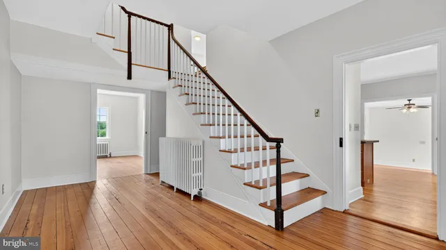 an empty room with wooden floor and a window