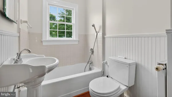 a bathroom with a shower a sink and a mirror