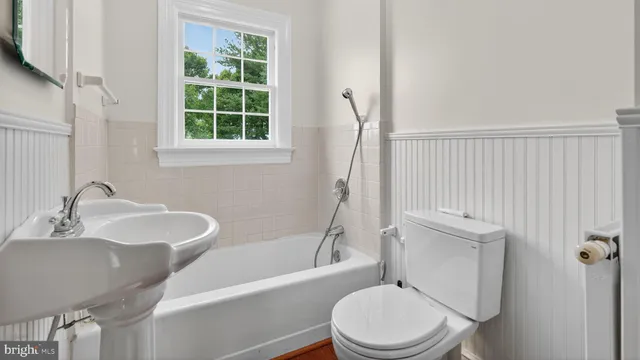 a bathroom with a shower a sink and a mirror