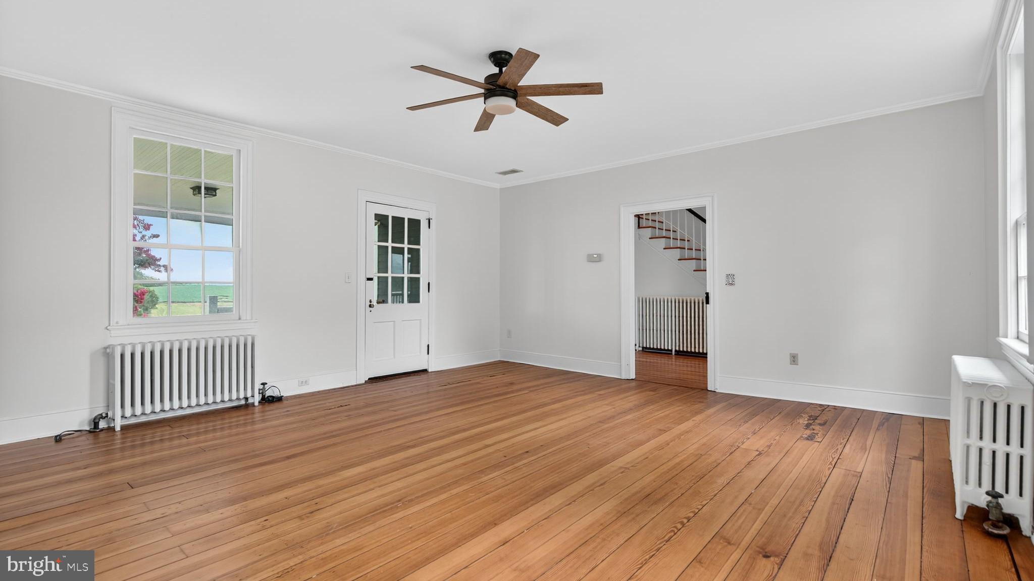 9534 Spring Hill Lane Rixeyville, VA 22737 - Photo 44 of 70 wooden floor in an empty room with a window and wooden floor