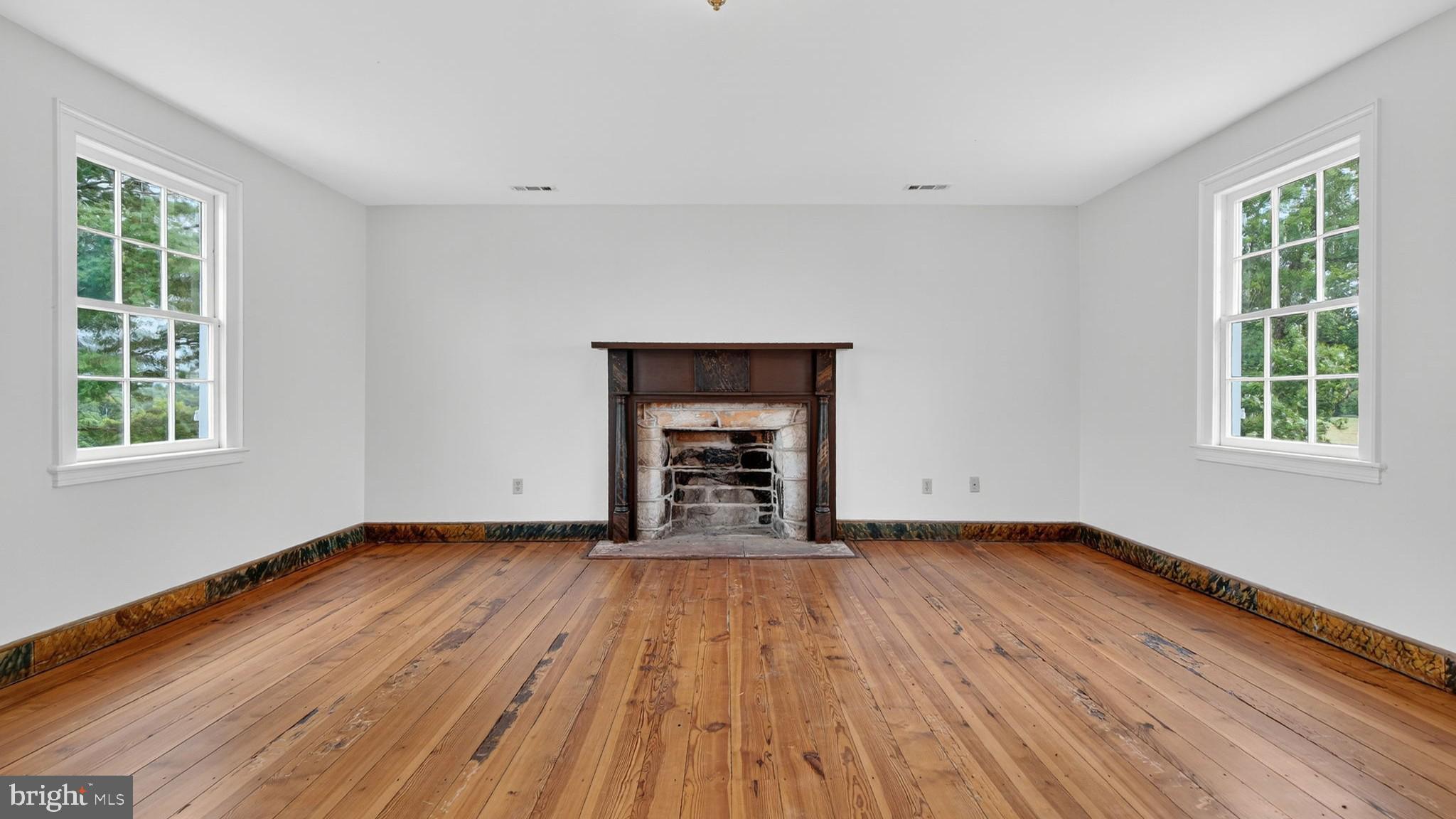 9534 Spring Hill Lane Rixeyville, VA 22737 - Photo 47 of 70 a view of an empty room with window and wooden floor
