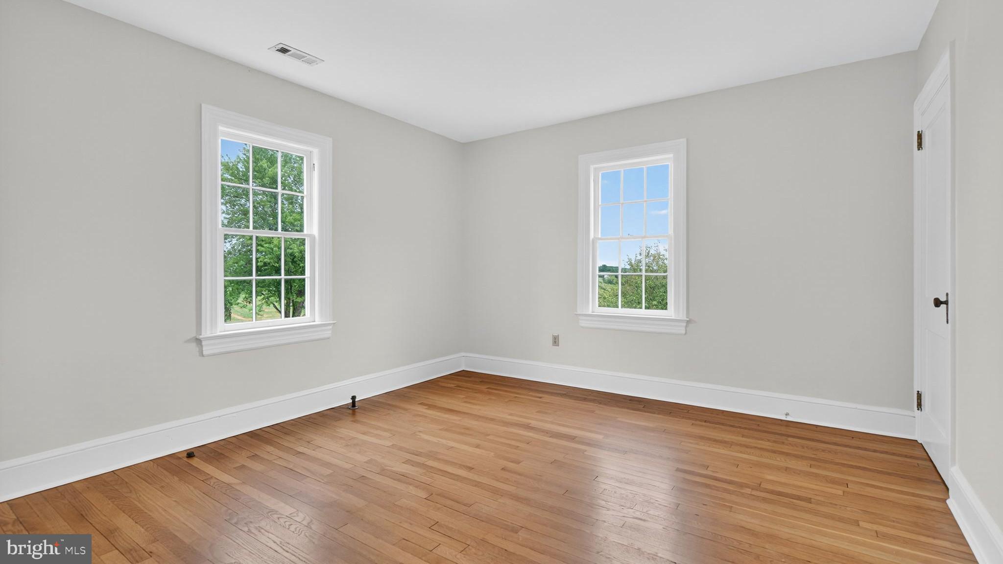 9534 Spring Hill Lane Rixeyville, VA 22737 - Photo 53 of 70 a view of an empty room with wooden floor and a window