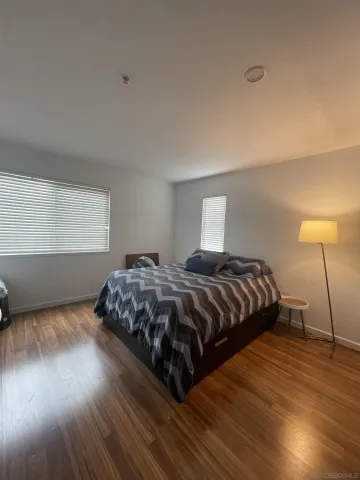 a living room with furniture a window and a flat screen tv