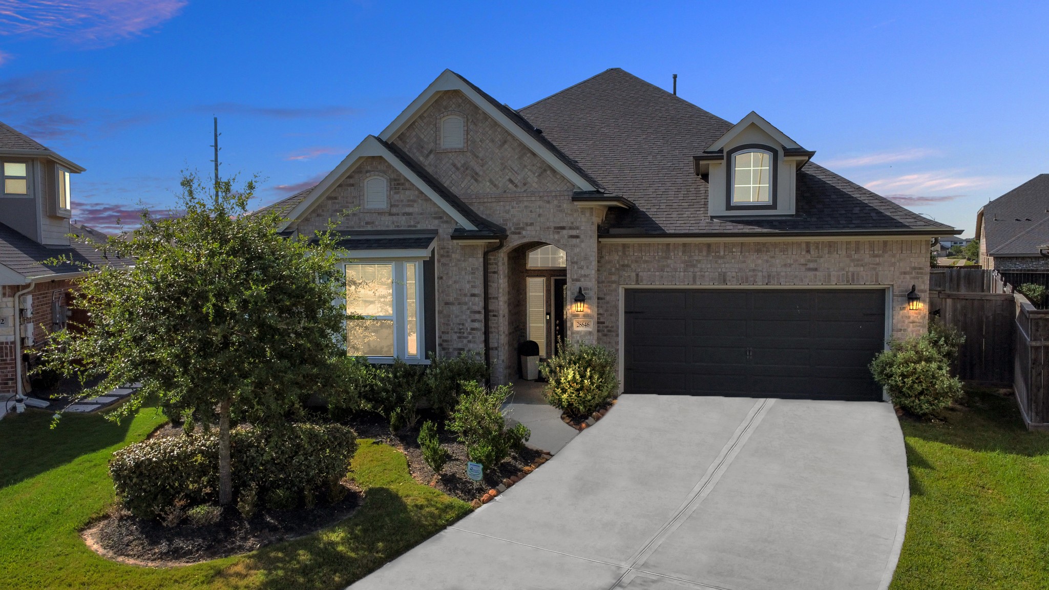 28646 Monarch Cliffs Drive Fulshear, TX 77441 - Photo 1 of 33 a front view of a house with a garden and plants