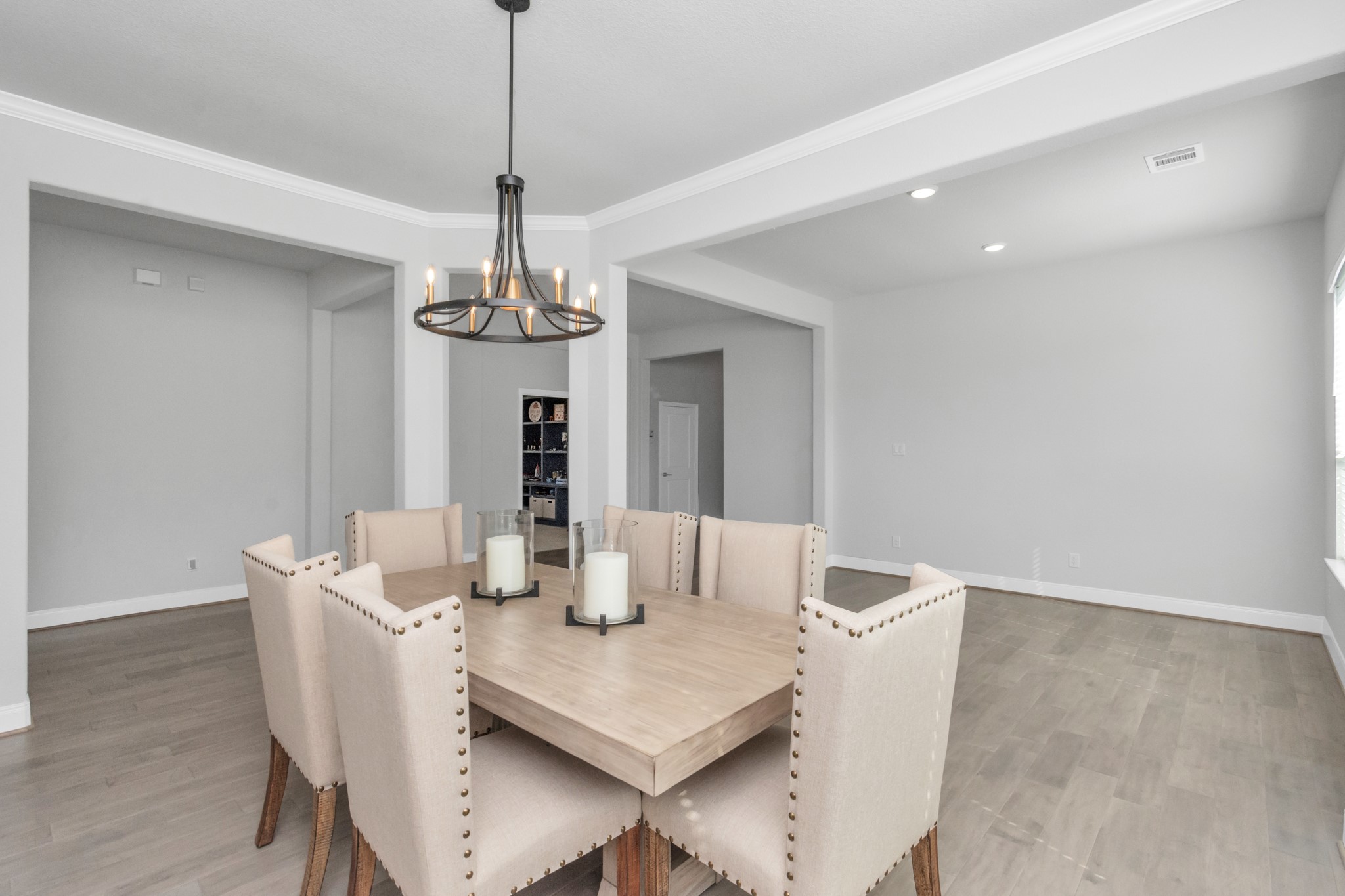28646 Monarch Cliffs Drive Fulshear, TX 77441 - Photo 18 of 33 a dining room with wooden floor a chandelier a wooden table and chairs