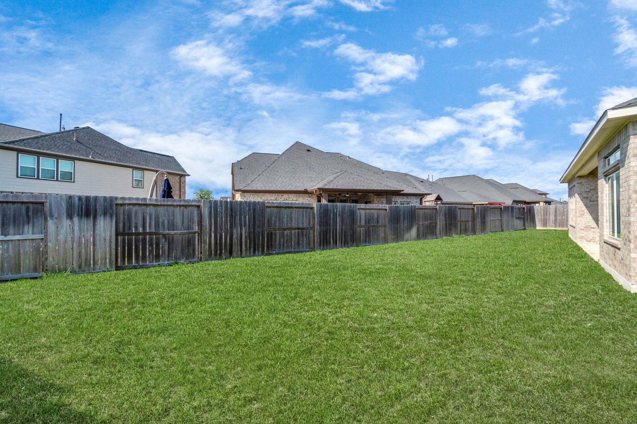 28646 Monarch Cliffs Drive Fulshear, TX 77441 - Photo 32 of 33 a view of a house with backyard and wooden fence
