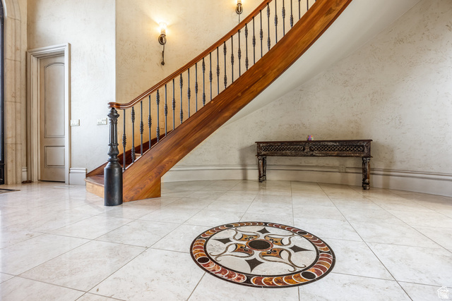 694 West Cephus Road Draper, UT 84020 - Photo 12 of 148 Grand entryway featuring a winding staircase with wood banister and wrought iron spindles