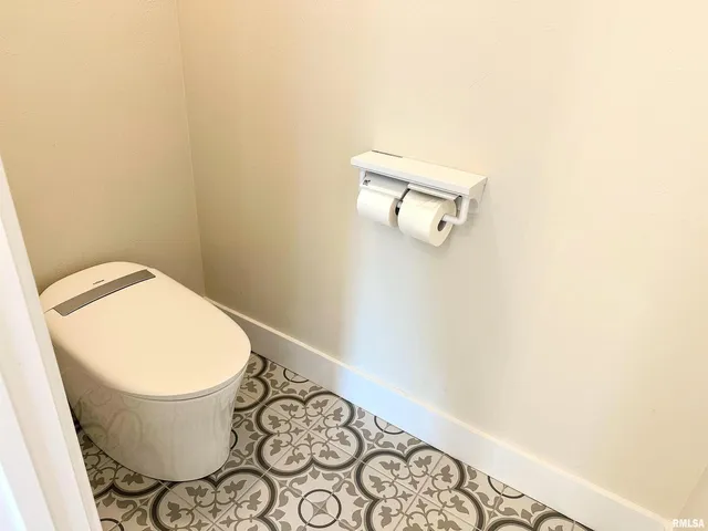 a white bath tub sitting next to a toilet